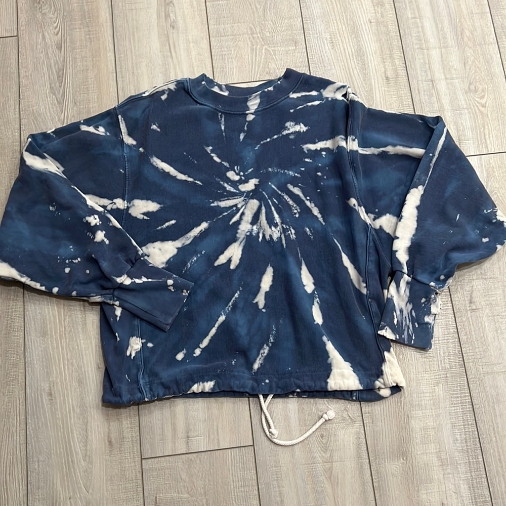 Tie dye distressed sweater. Can be tied on the bottom hem to tighten.
